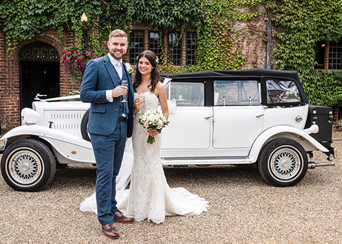 bride and groom with classic car at seckford hall