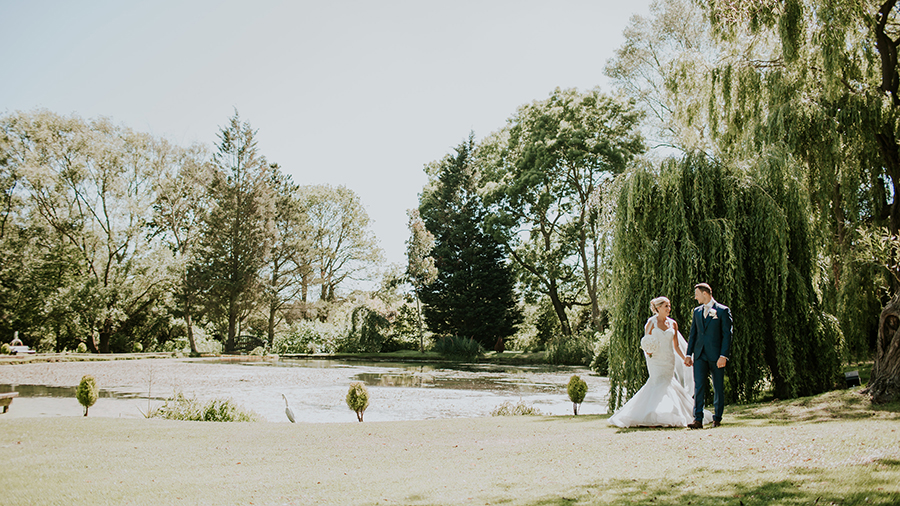 bride and groom at seckford hall lake and gardens
