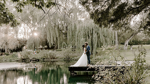 bride and groom at seckford hall lake